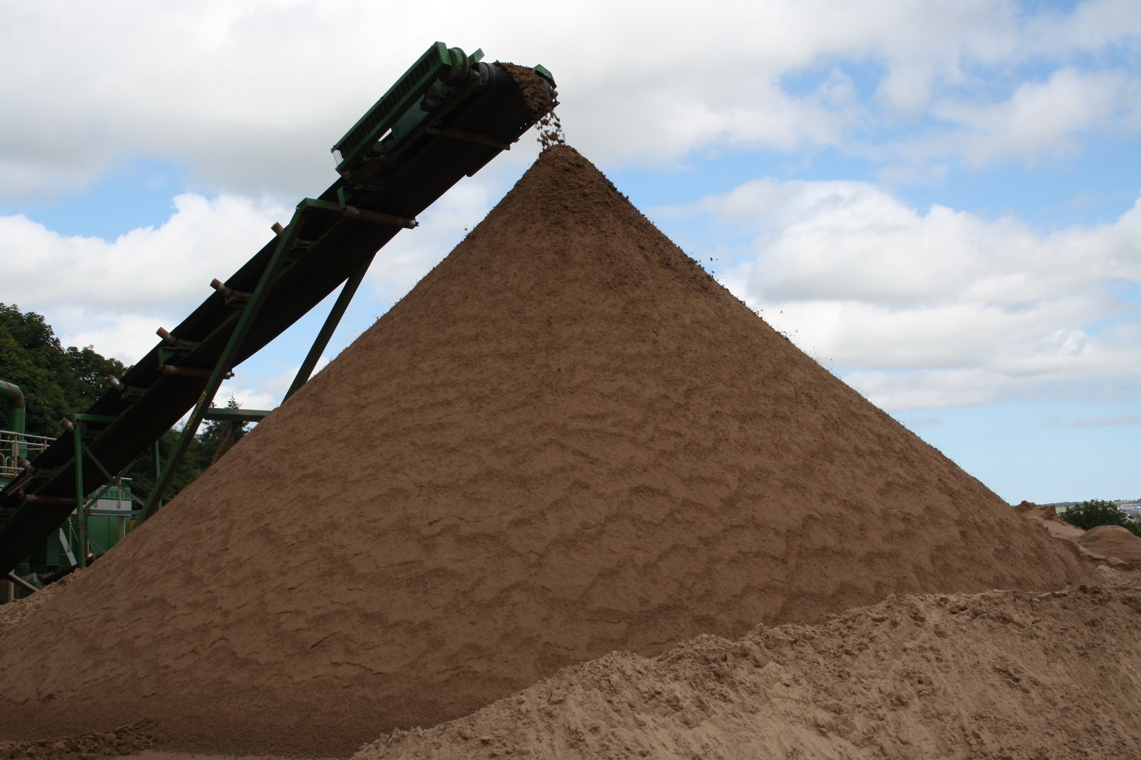 Washed-sand stockpile showing its fine granular texture — reference photo, not the exact supplied product